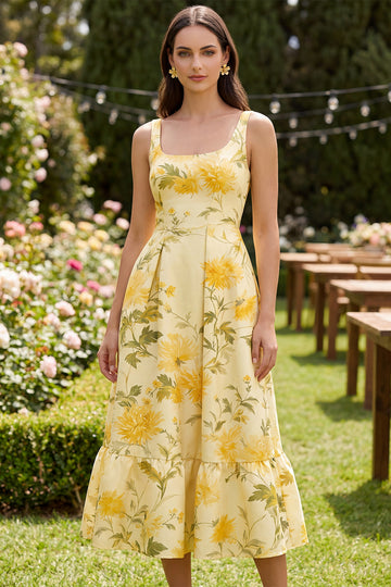 Woman wearing a mustard yellow sundress as an outdoor summer wedding guest